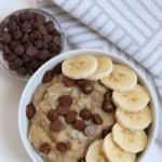 a bowl of peanut butter banana oatmeal with bananas and chocolate chips on top