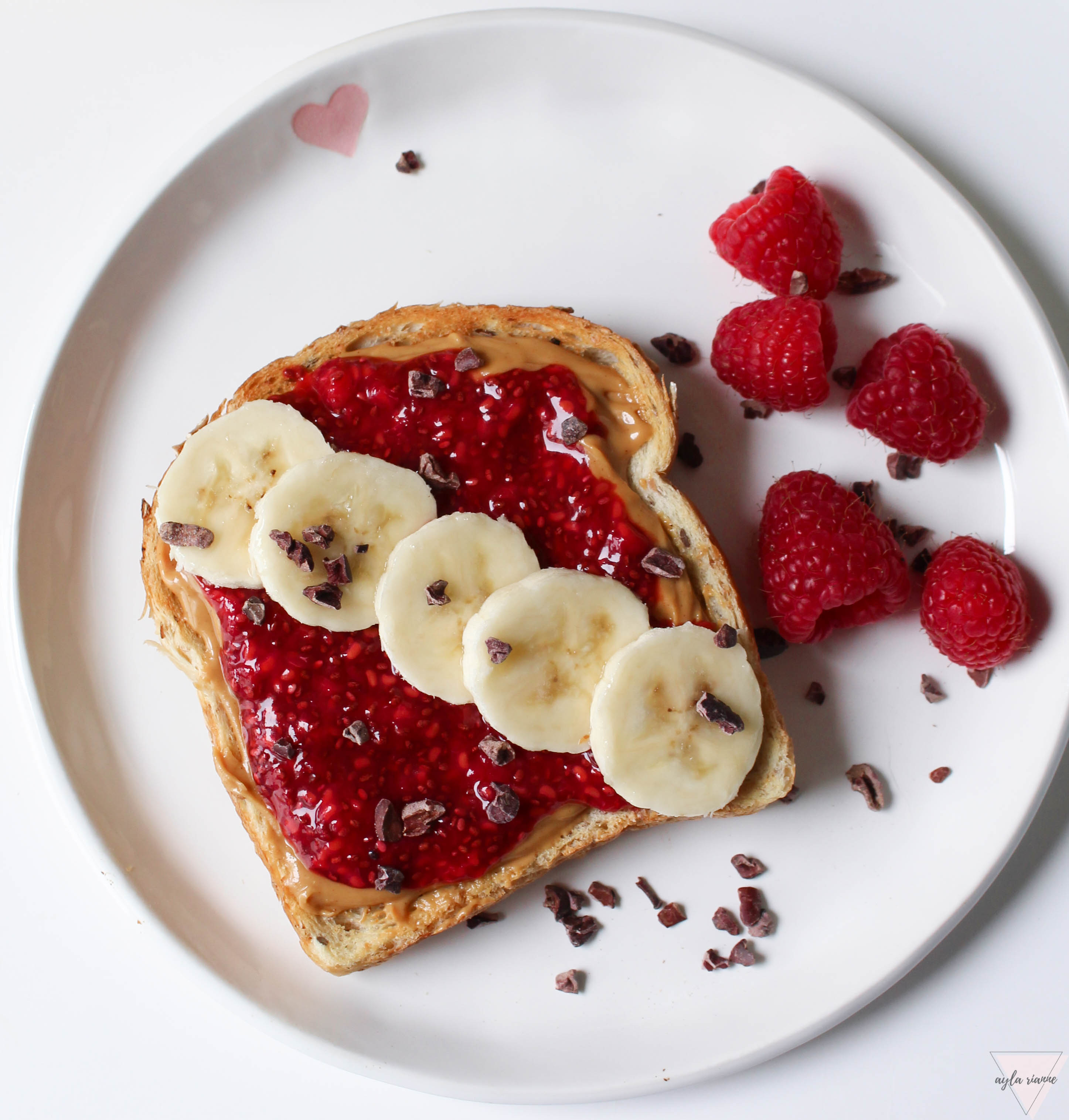 Peanut butter and homemade chia seed jam toast with bananas on top and cocoa nibs #aylarianne #chiaseedjam #pbandjtoast