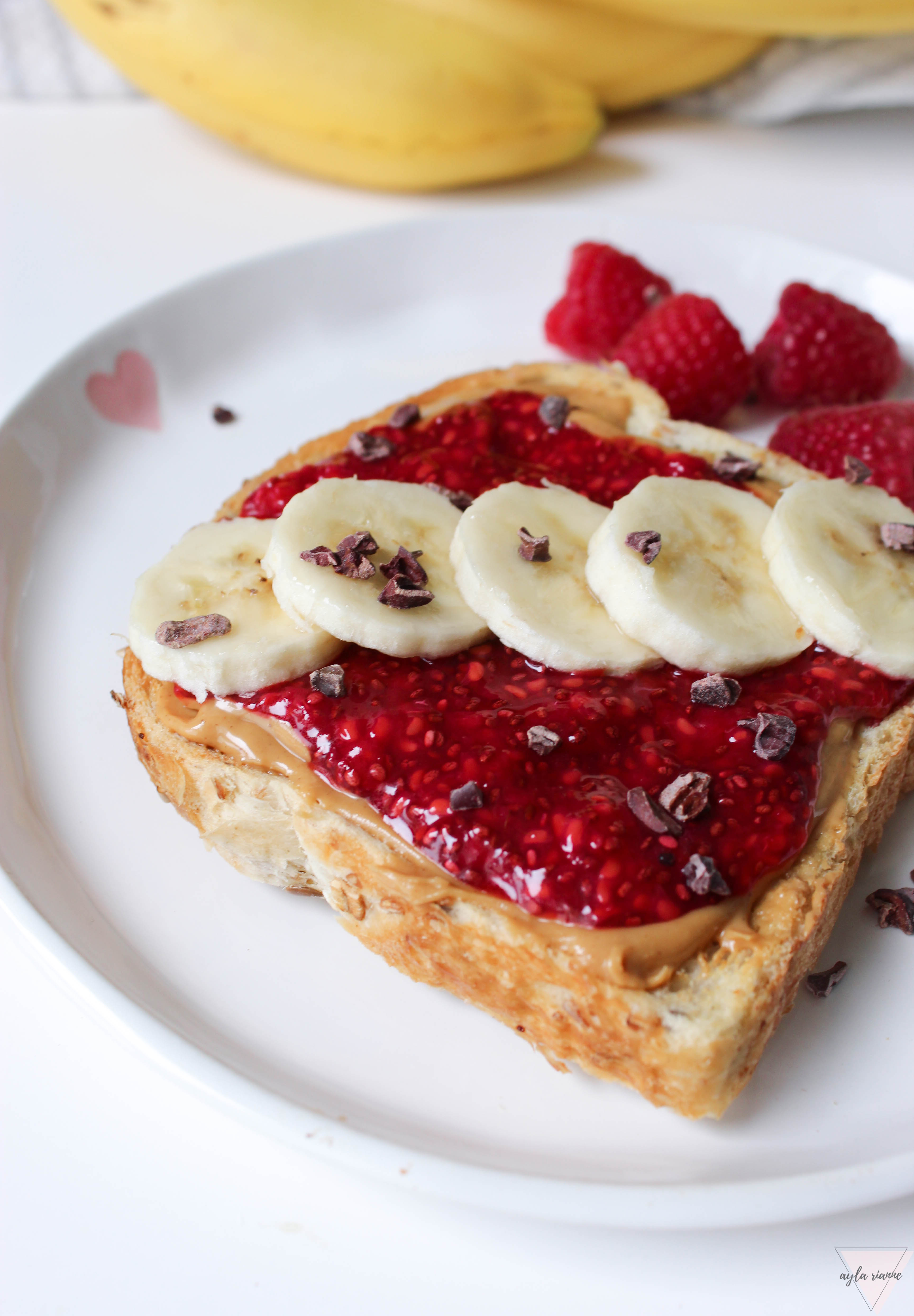 Peanut butter and homemade chia seed jam toast with bananas on top and cocoa nibs #aylarianne #chiaseedjam #pbandjtoast