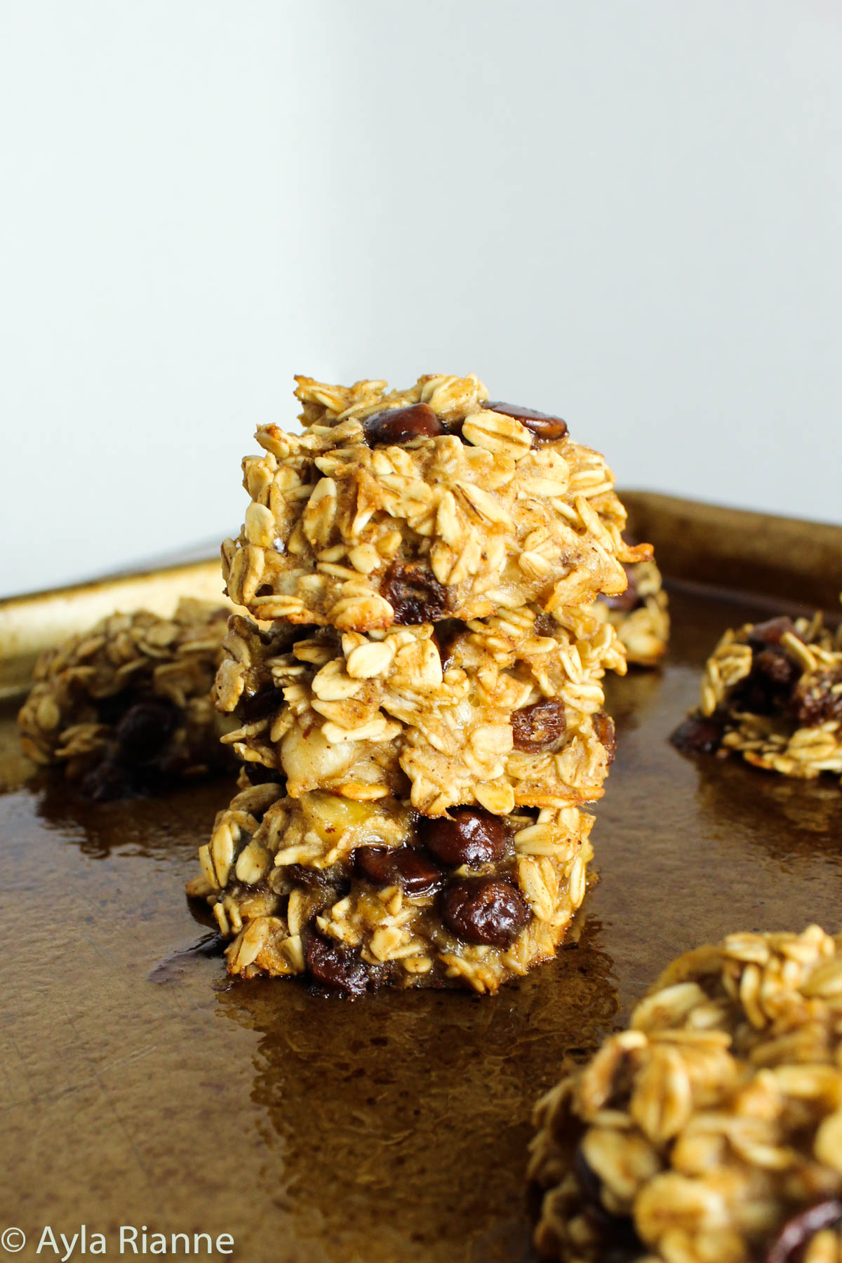 stack of 3 banana breakfast cookies on a baking sheet