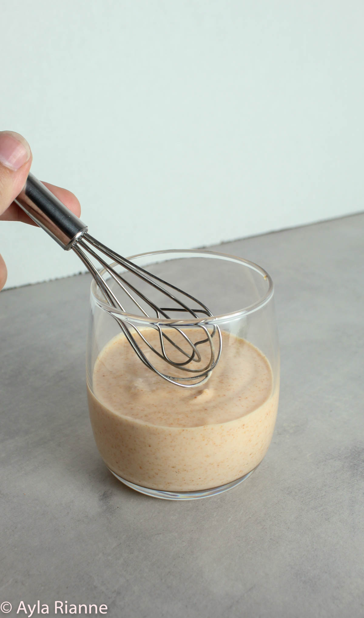Cup of yum yum sauce with whisk