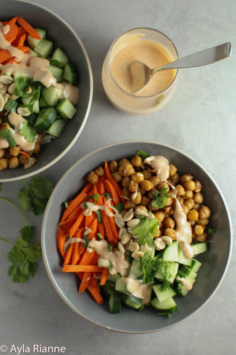 One full yum yum bowl with carrots, cucumbers, chickpeas and yum yum sauce. One partial yum yum bowl and one cup of yum yum sauce.