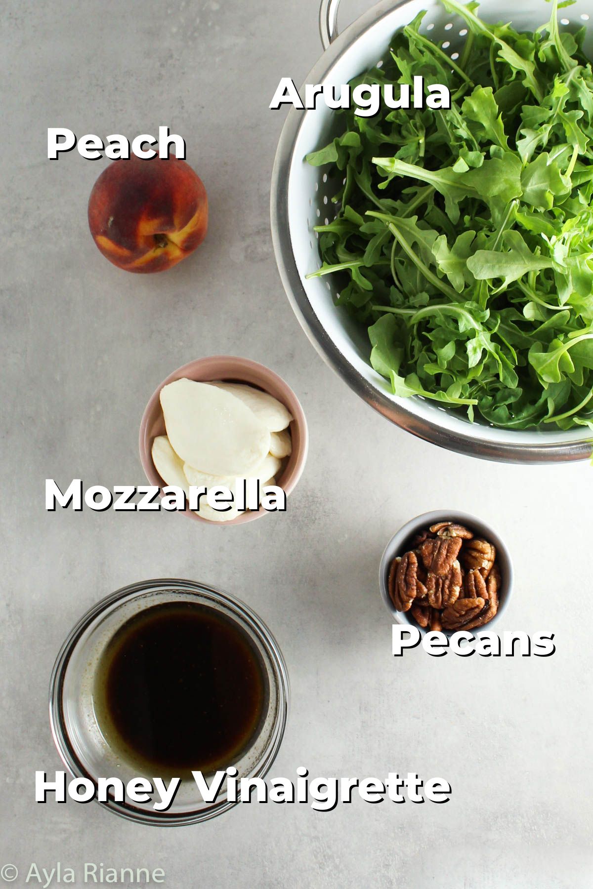 ingredients for peach arugula salad including arugula, peach, mozzarella, pecans, and honey vinaigrette