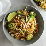 a bowl of peanut noodles with a second bowl in the background