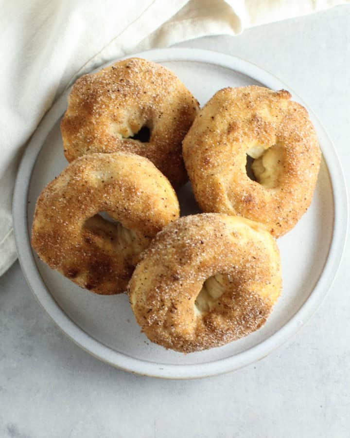 a plate of cinnamon sugar donuts