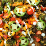 close up of broccoli nachos with toppings
