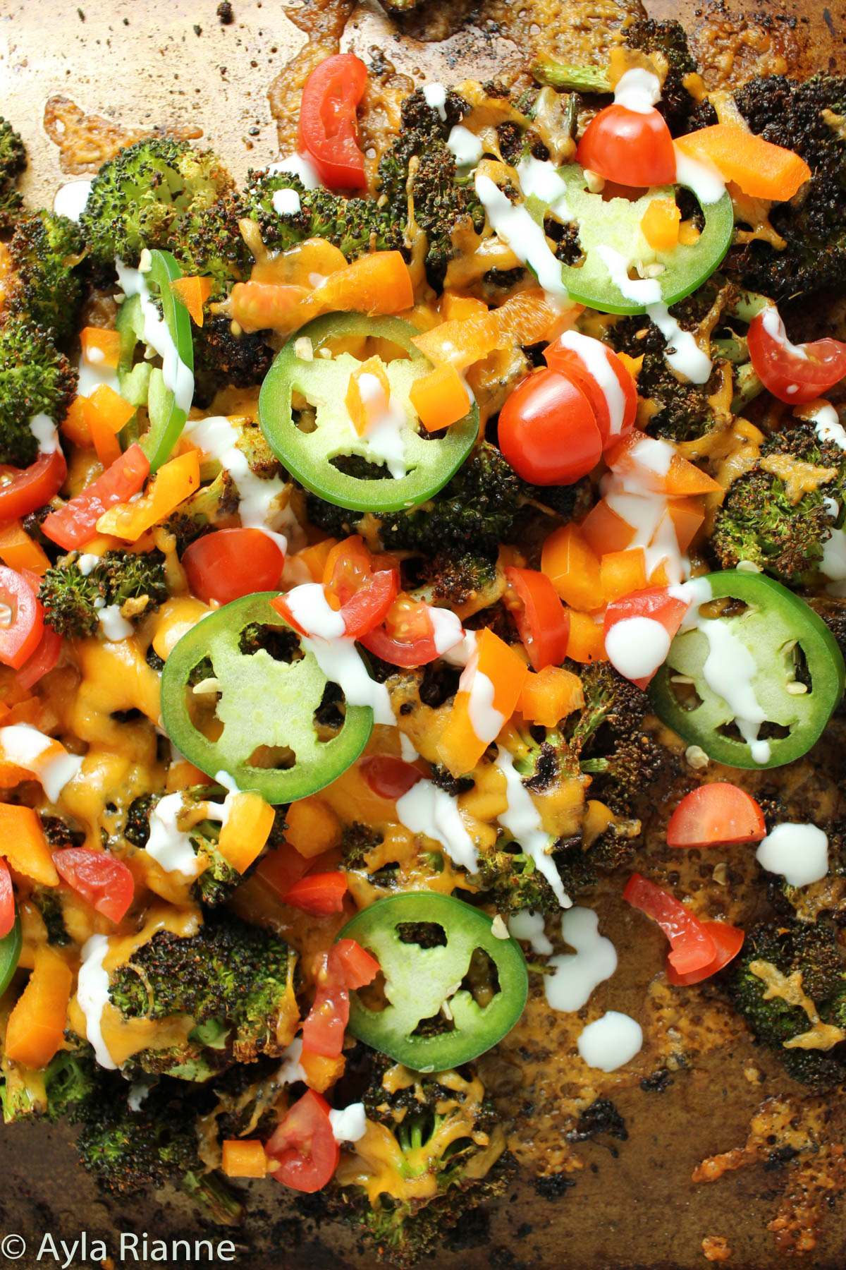 close up of broccoli nachos with toppings