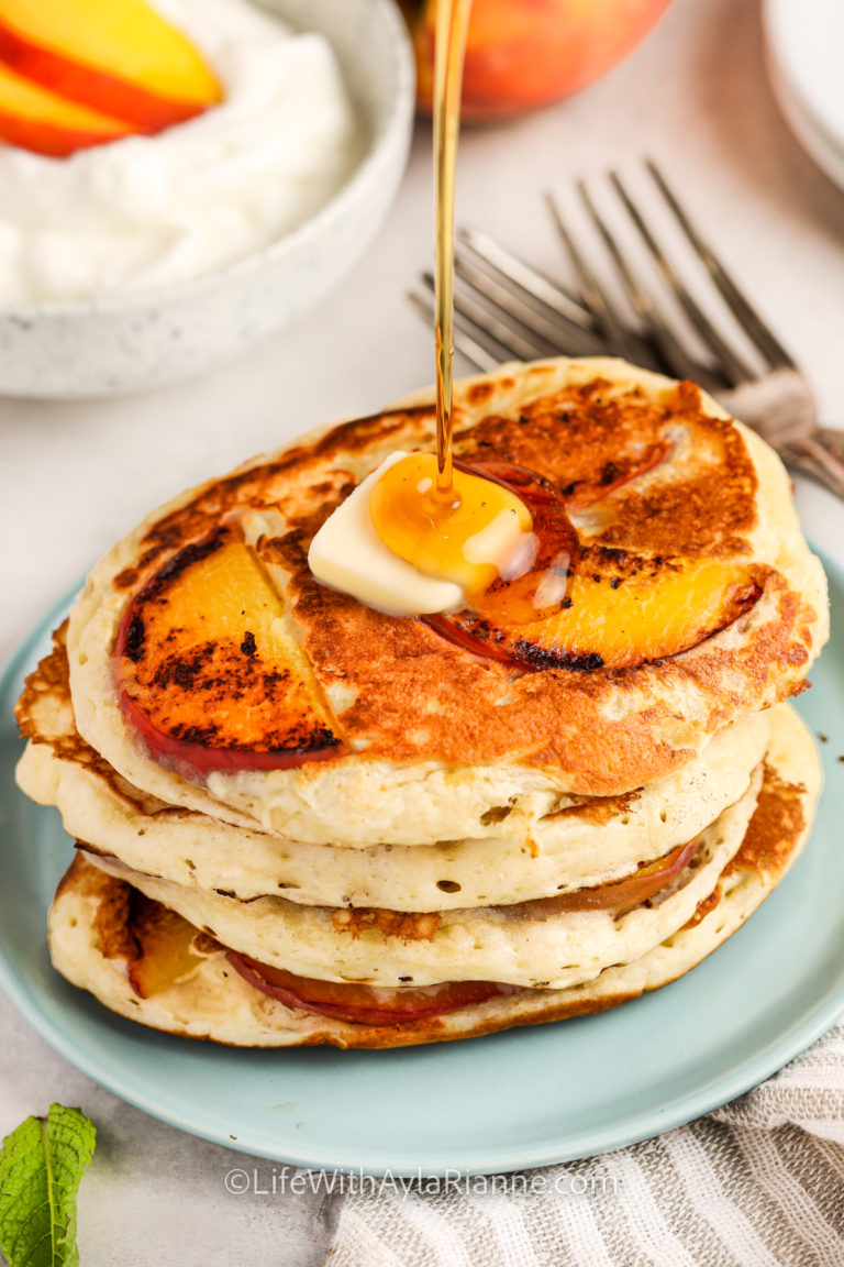 pouring syrup over Peach Pancakes