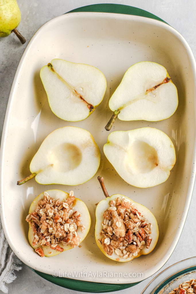 pears in a baking dish. A few are topped with crumble mixture to make baked pears