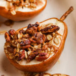 A baked pear topped with crumble mixture