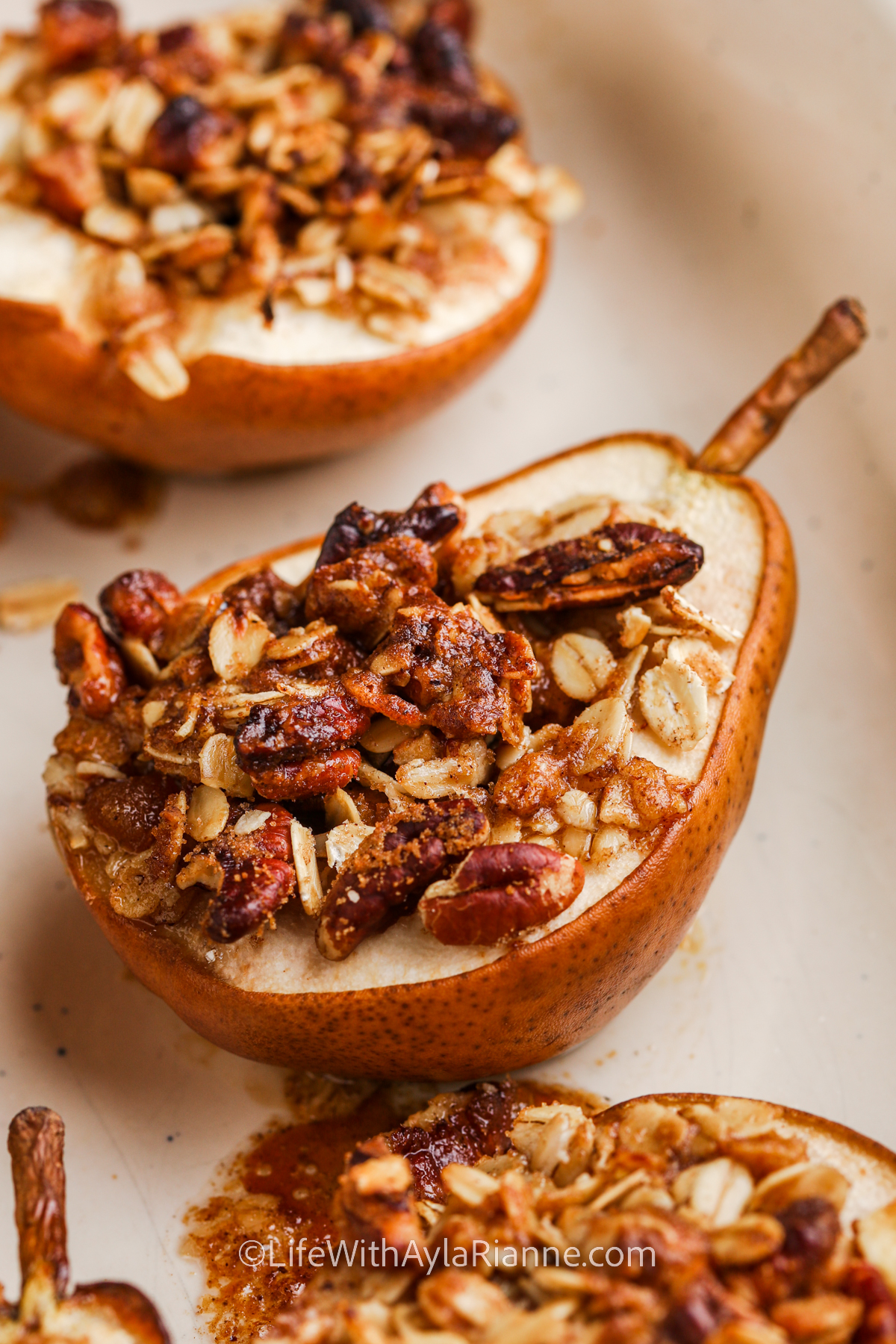 A baked pear topped with crumble mixture
