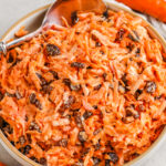 simple Carrot and Raisin Salad in a bowl with a spoon