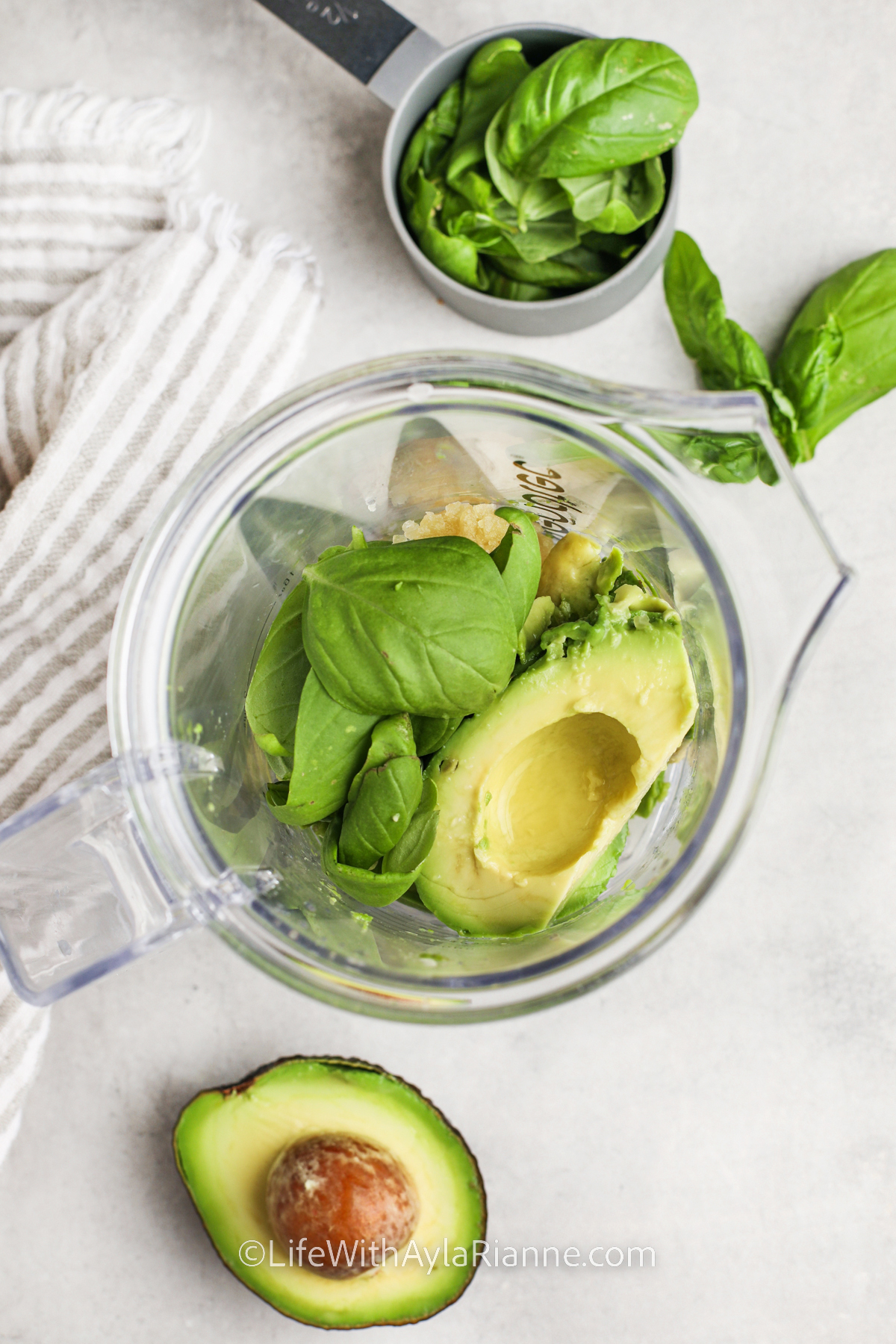 Ingredients to make the avocado sauce for past in a food processor