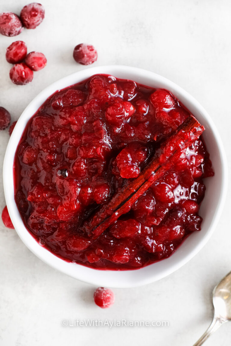 cranberry sauce with orange juice in a white serving bowl with a cinnamon stick