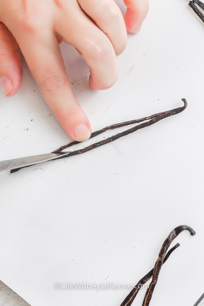 cutting vanilla beans with a knife for how to make vanilla