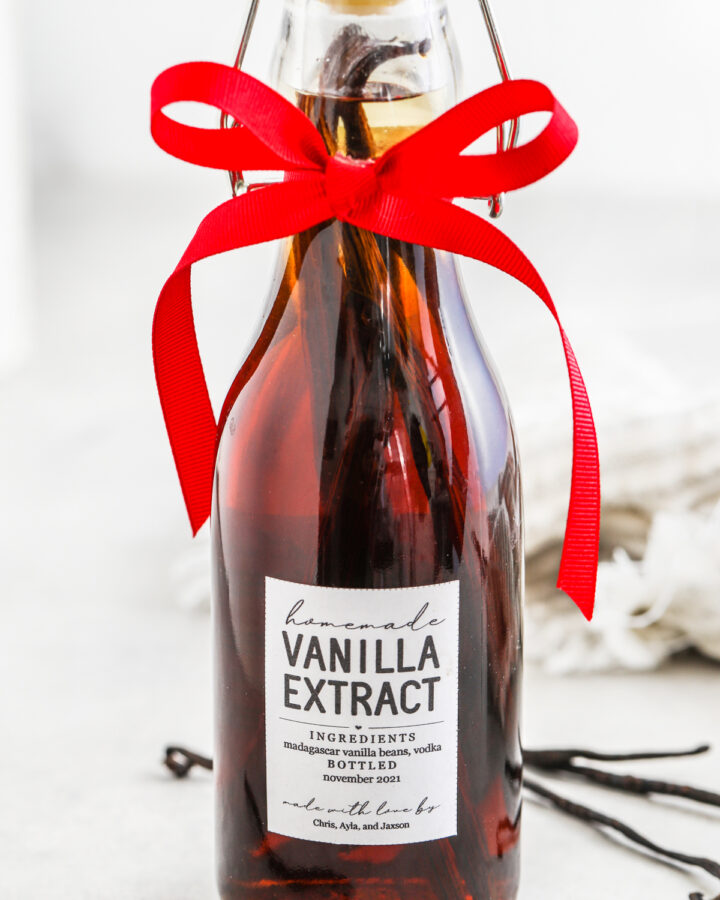 a bottle of homemade vanilla with a label and a bow for how to make vanilla