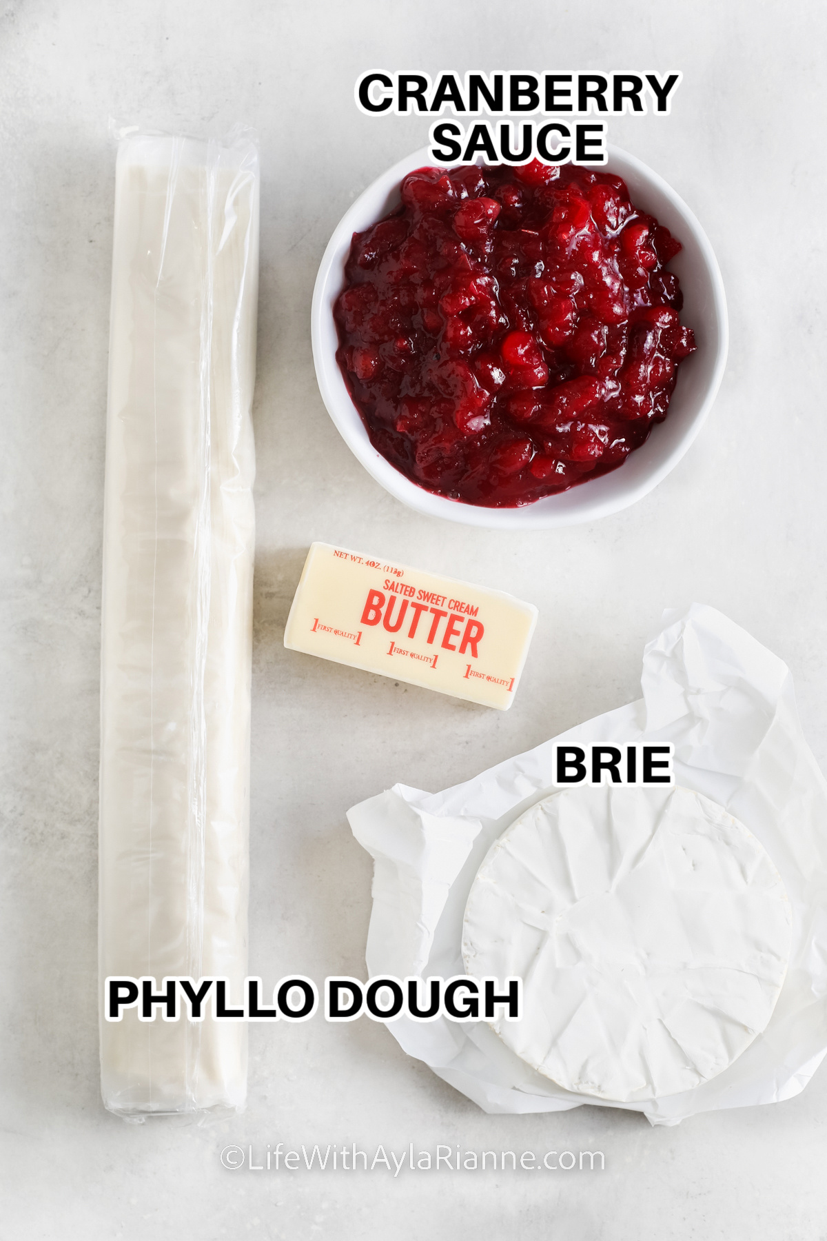 ingredients to make Brie Cranberry Bites including cranberry sauce, phyllo dough, butter, and brie