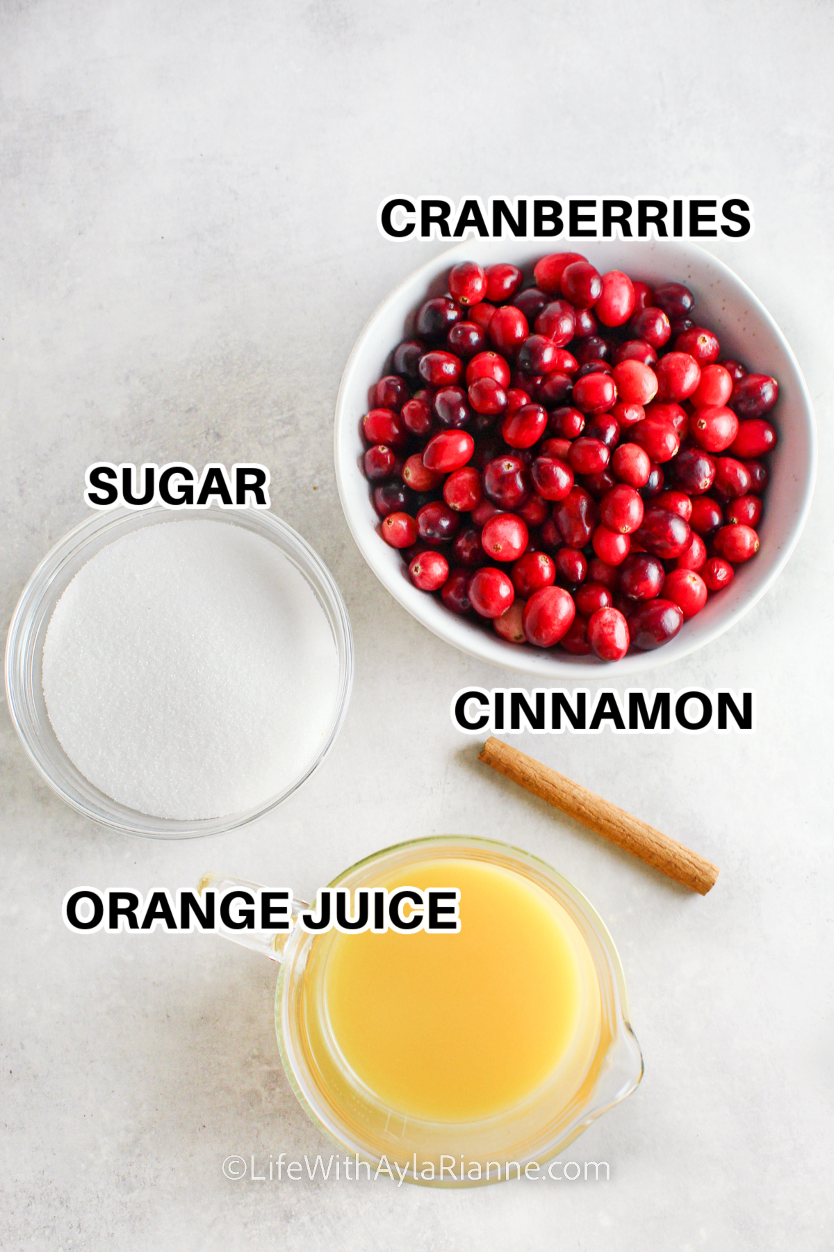 ingredients for cranberry sauce with orange juice including cranberries, sugar, orange juice, and cinnamon
