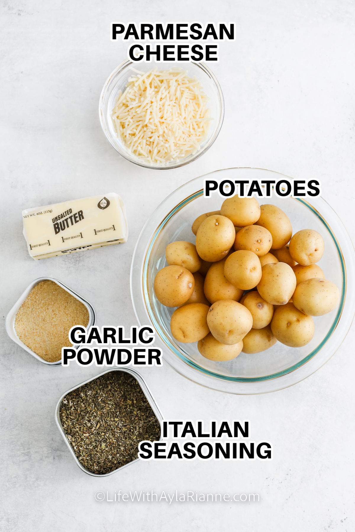 ingredients to make parmesan smashed potatoes including parmesan cheese, potatoes, butter, garlic powder, and Italian seasoning