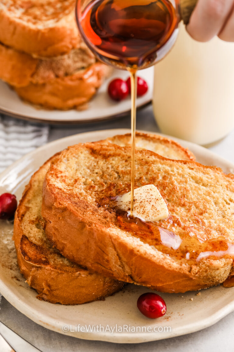 Eggnog French Toast on a plate with syrup being poured on