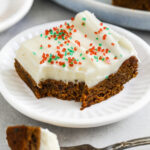 square of gingerbread bar on a plate with a bite on a fork