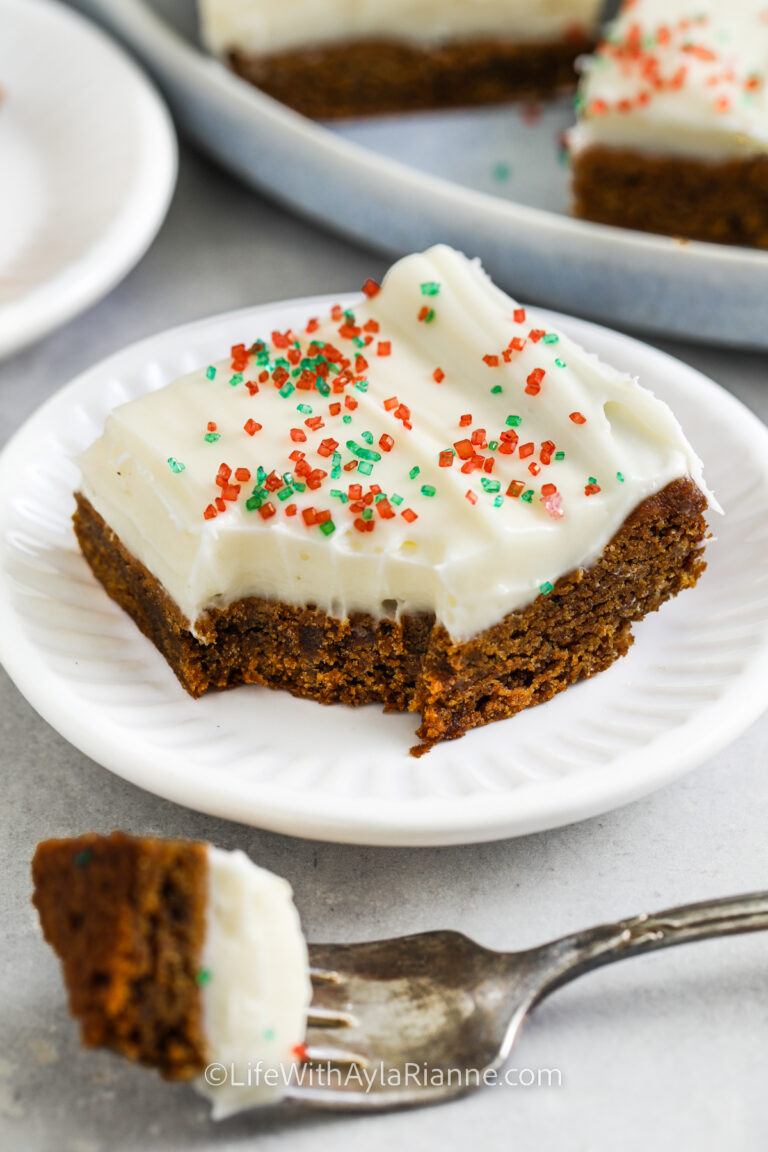 square of gingerbread bar on a plate with a bite on a fork
