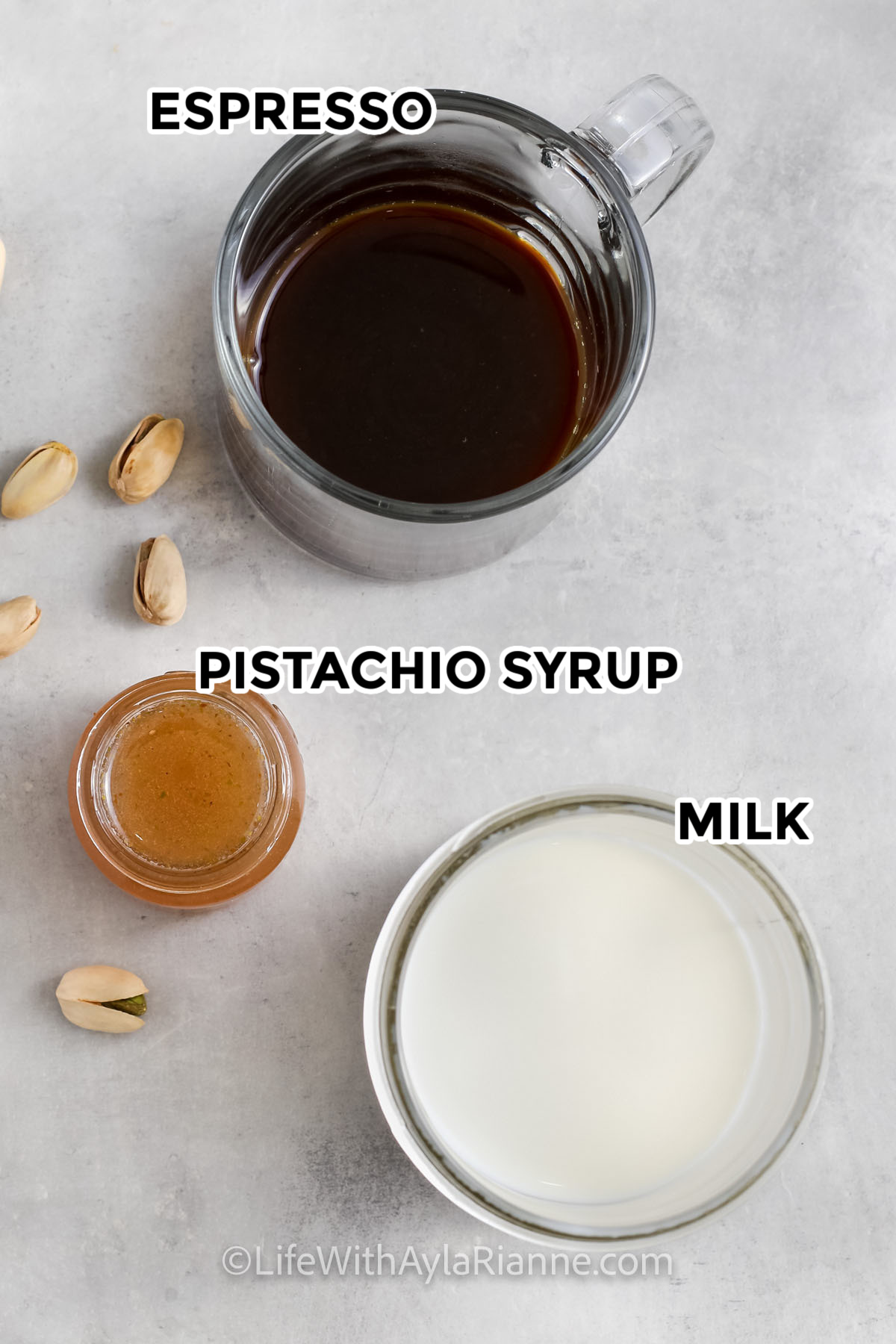ingredients to make pistachio latte including espresso, pistachio syrup, and milk.