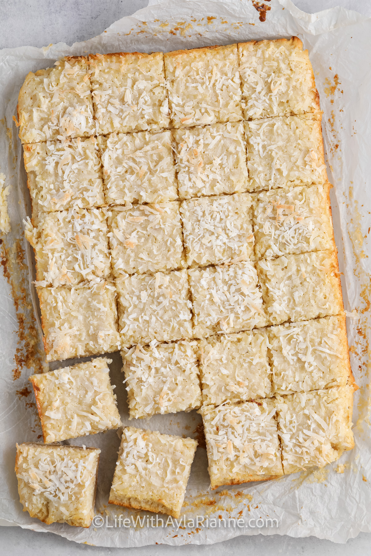 A pan of coconut bars sliced into squares