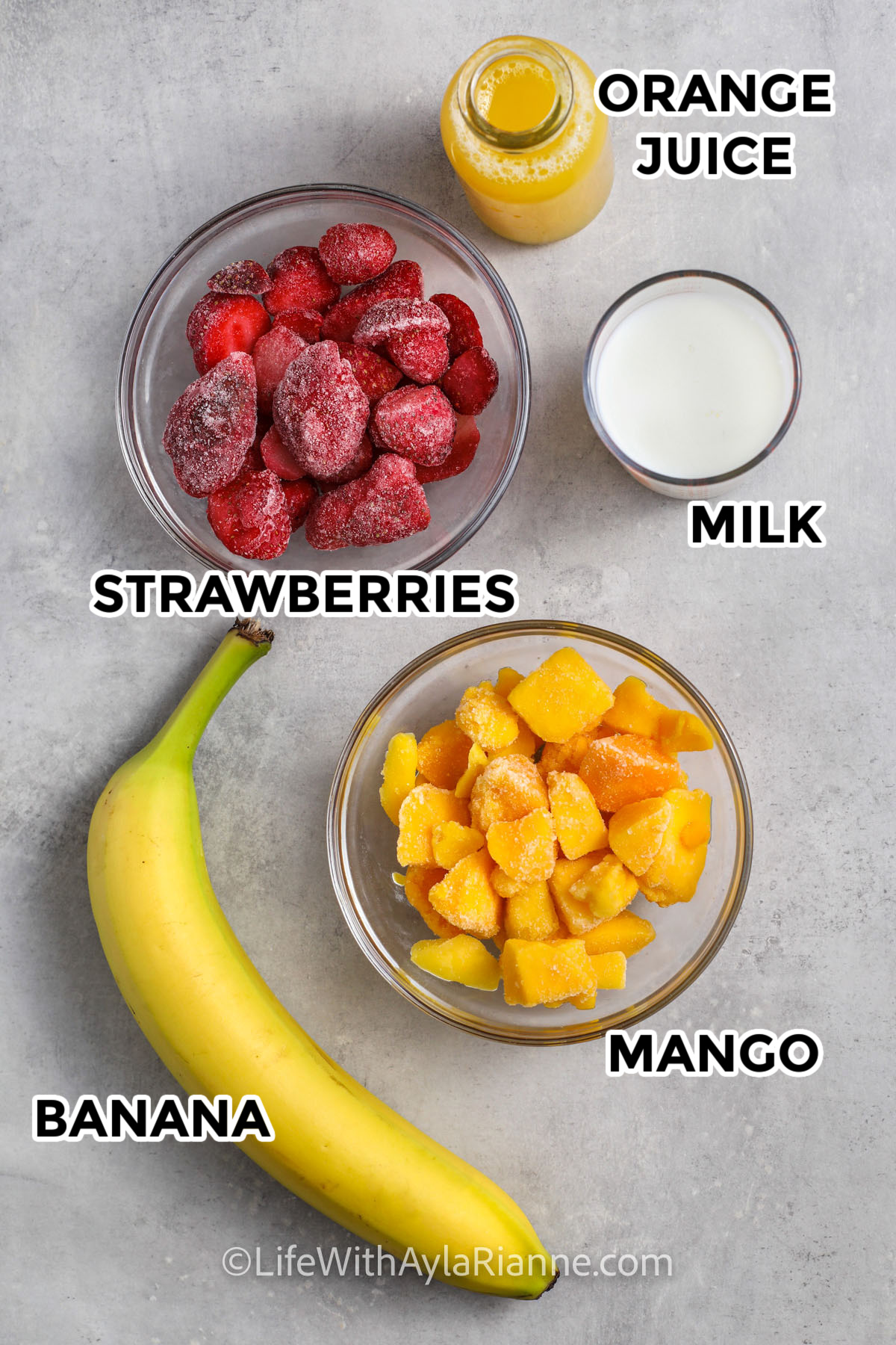 Strawberry Mango Smoothie ingredients including strawberries, orange juice, milk, mango, and banana