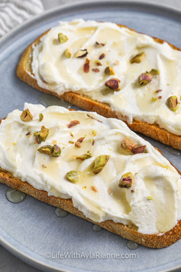 Ricotta Toast on a plate with honey and pistachios