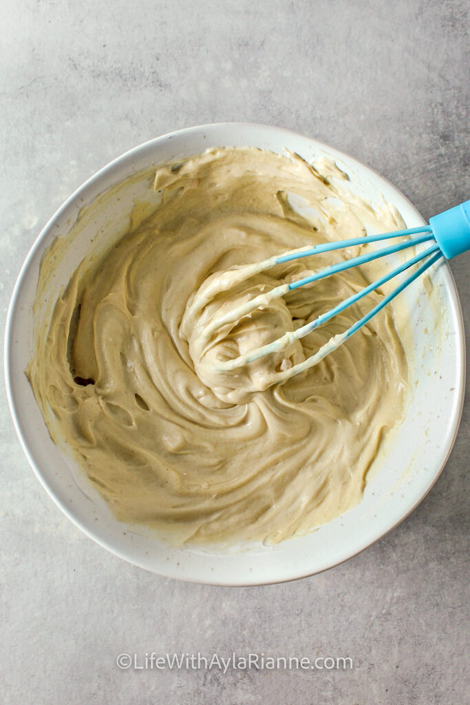 a bowl showing the smooth consistency of the dip