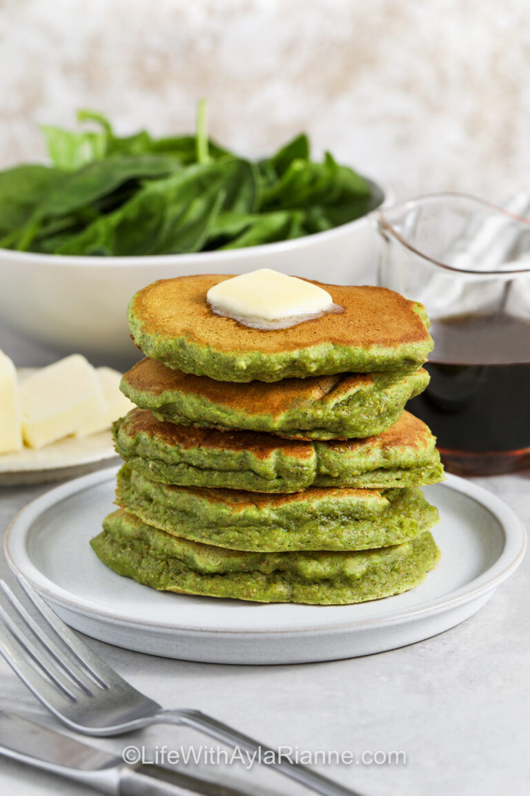 butter on a stack of Spinach Pancakes