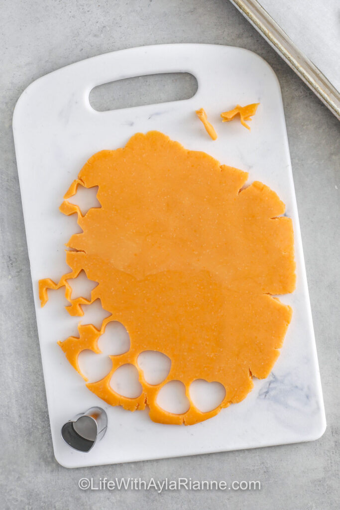 cutting out shapes to make Homemade Cheese Crackers