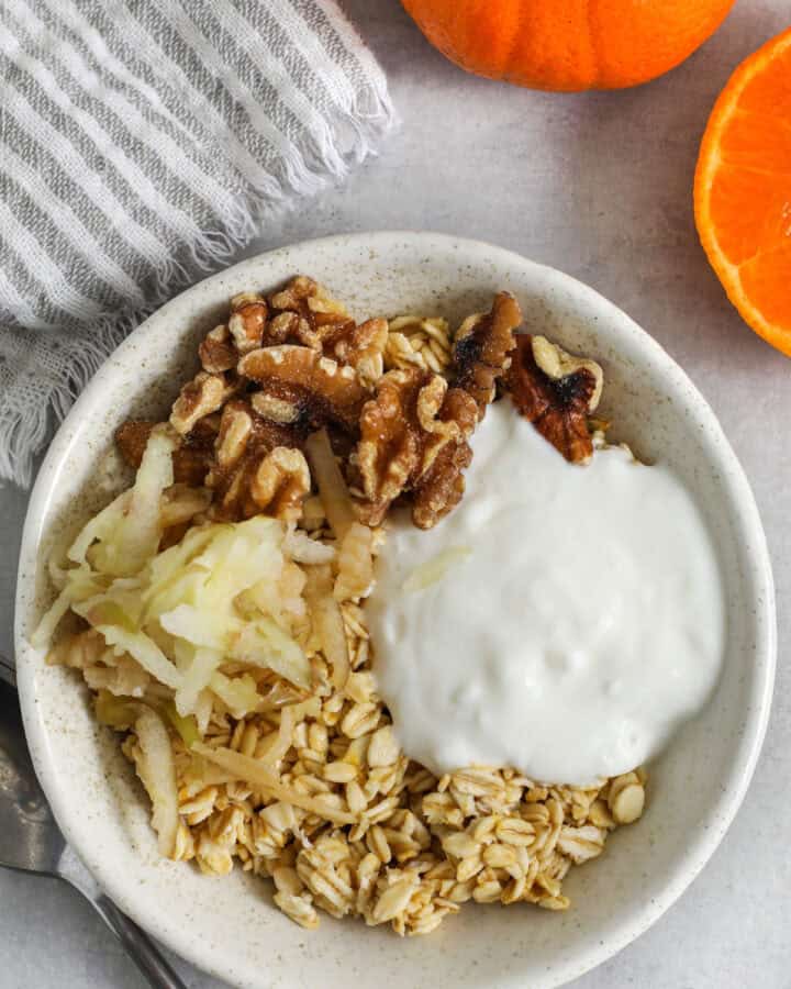 Princess Diana Oats in a bowl with oranges and a napkin