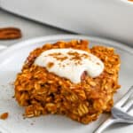 close up of a slice of Pumpkin Pie Baked Oatmeal with icing and a fork