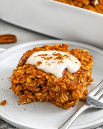 close up of a slice of Pumpkin Pie Baked Oatmeal with icing and a fork