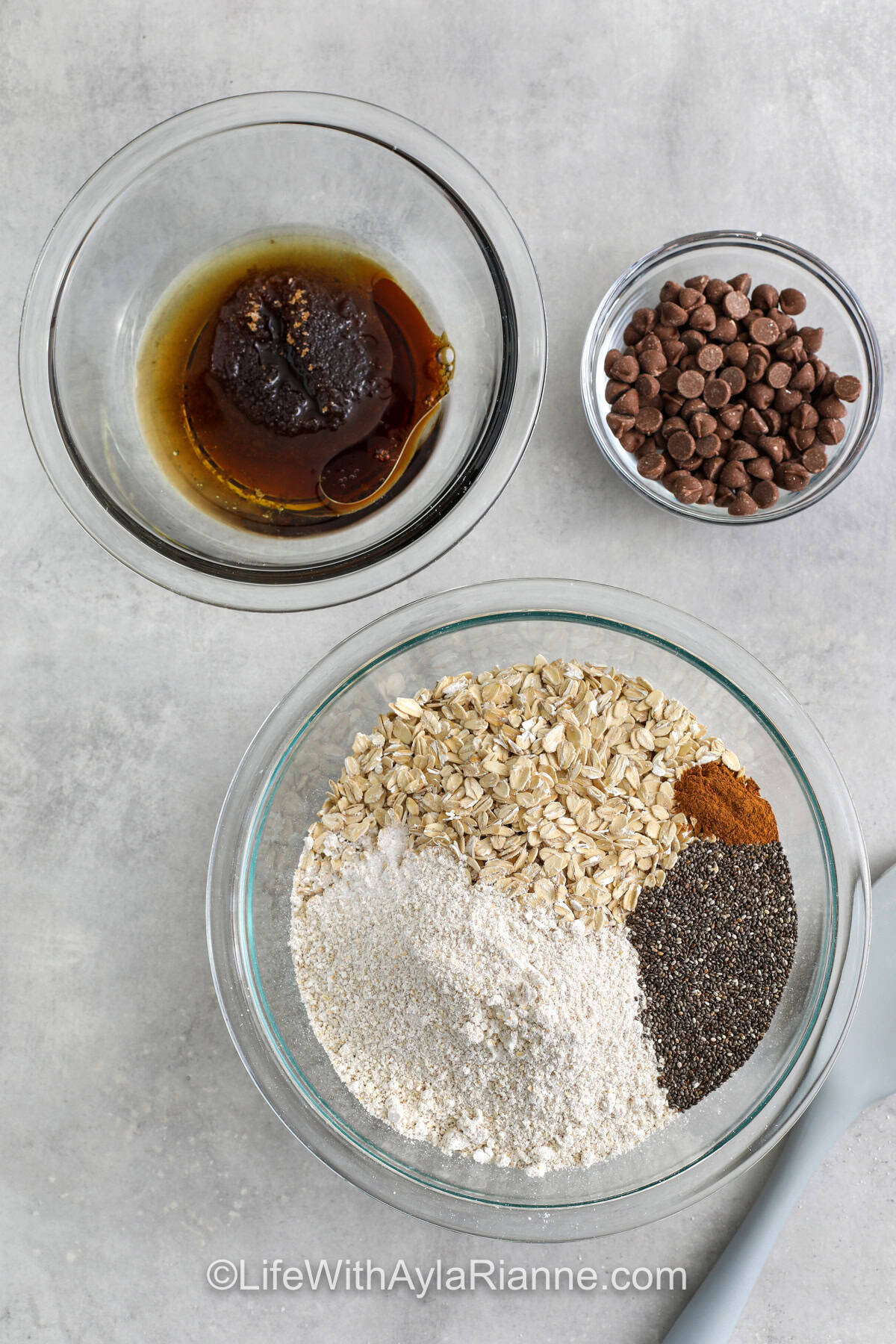 wet and dry ingredients in bowls to make Chocolate Chip Cookie Granola